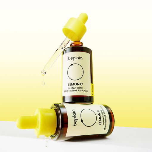 ThatKBeautyShop.com beplain | Lemon C Glutathione Brightening Ampoule Two bottles of beplain Lemon C skincare product on a white surface with a yellow background