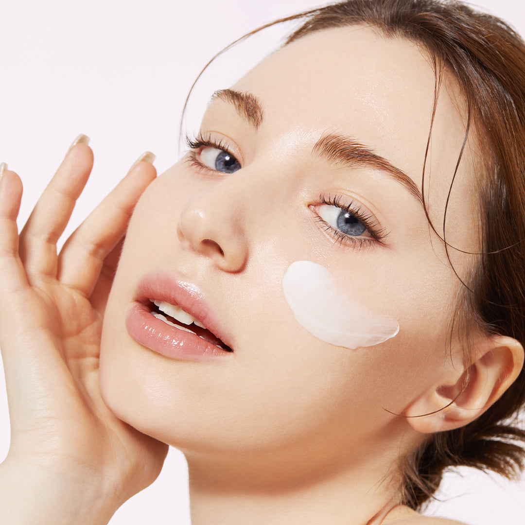AgelessBeauty3000.com  medicube | Triple Collagen Cream    Woman applying cream to her face with a white background