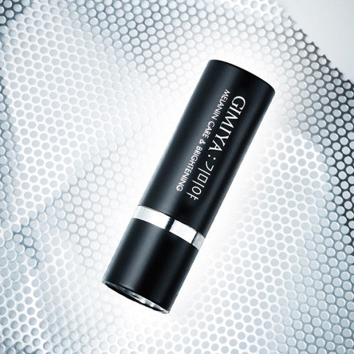 AgelessBeauty3000.com  TONYMOLY | GIMIYA Melanin Care & Brightening Ampoule Stick  Black cosmetic tube with silver cap on a textured gray background