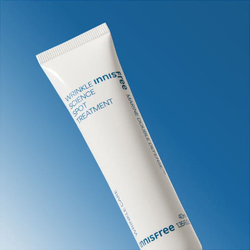 Experience the Seoul Glow on ThatKBeautyShop.com    Innisfree wrinkle science spot treatment tube on a blue background