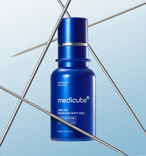 AgelessBeauty3000.com  medicube |One Day Exosome Shot Pore Ampoule 2000 Blue Medicube serum bottle on a light blue background with metal rods.