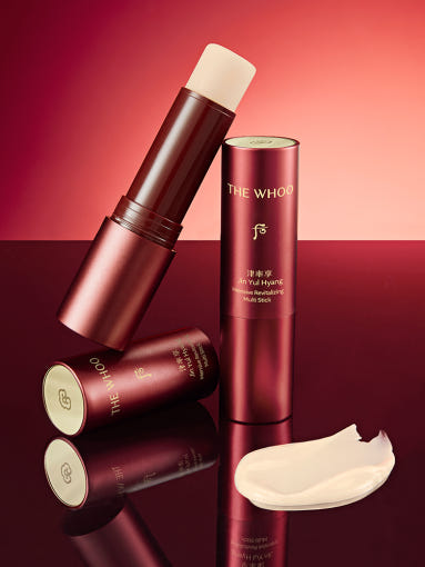 Red cylindrical container with 'The Whoo' branding on a white background  AgelessBeauty3000.com  THE WHOO  |  Jinyulhyang Intensive Revitalizing Multi Stick