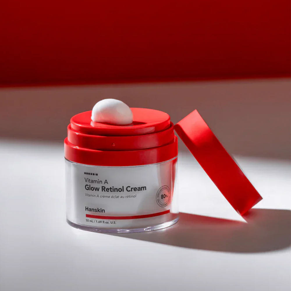 AgelessBeauty3000.com  Red and white skincare cream jar with a red lid on a light gray background