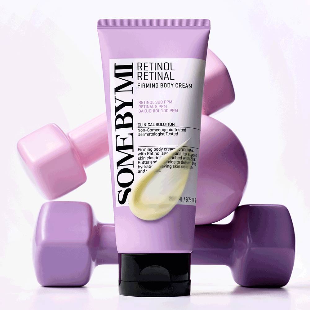 ThatKBeautyShop.com   SOME BY MI | Retinol Retinal Firming Body Cream    A squeeze tube of SOME BY MI Retinol Retinal Firming Body Cream stands upright in front of three pastel purple dumbbells on a clean white studio background.